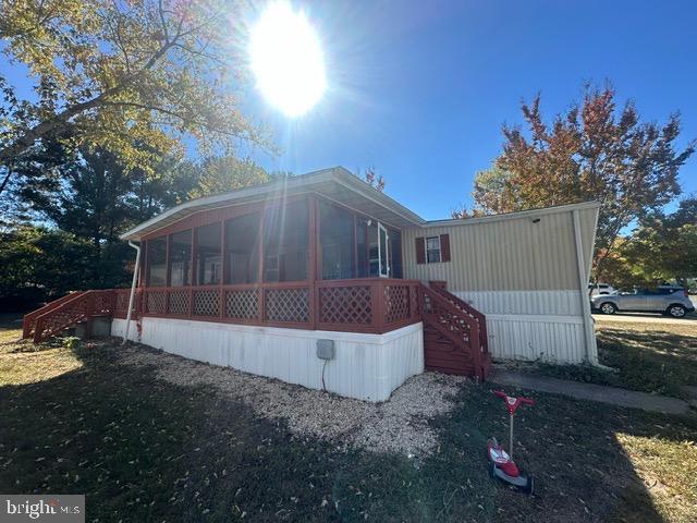 rear view of property with a sunroom