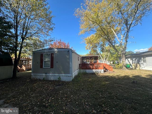 exterior space with a deck and a yard