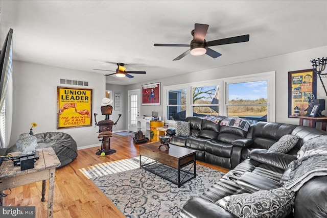 living room featuring ceiling fan and hardwood / wood-style flooring