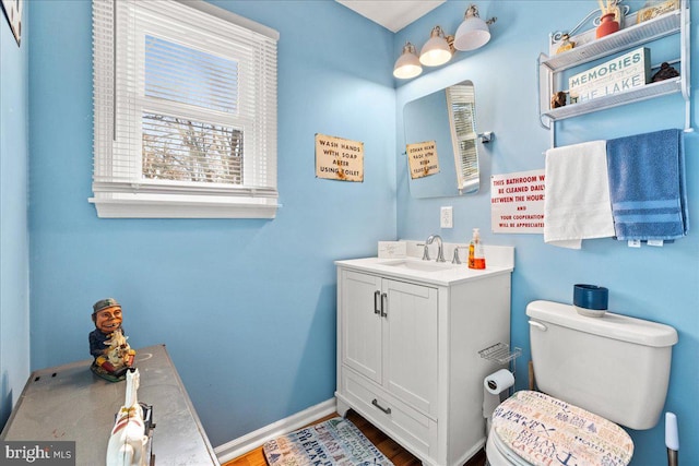 bathroom with vanity, wood-type flooring, and toilet