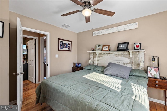 bedroom with hardwood / wood-style flooring and ceiling fan