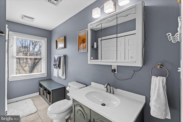 bathroom with tile patterned floors, vanity, and toilet