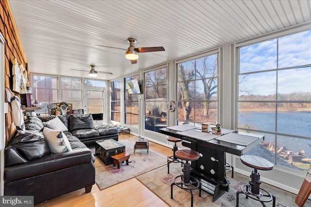 sunroom featuring ceiling fan and a wealth of natural light