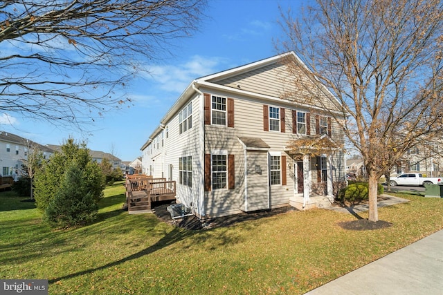 colonial house featuring a deck and a front lawn