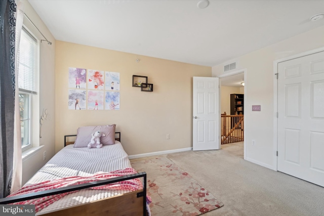 bedroom featuring light carpet