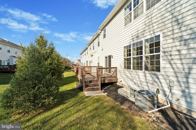 view of yard featuring central AC unit and a deck