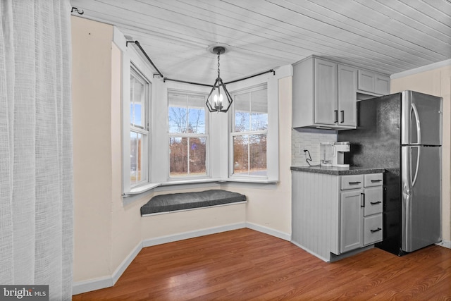 kitchen featuring gray cabinets, wood ceiling, and decorative light fixtures