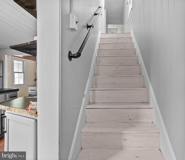 stairway with wood walls