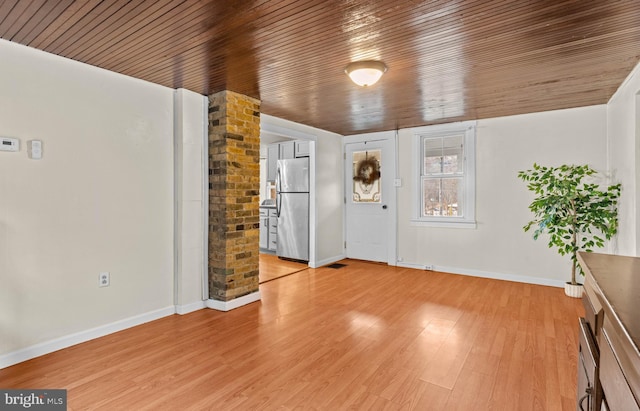 interior space featuring light hardwood / wood-style flooring and wood ceiling