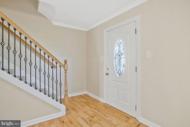 entryway with hardwood / wood-style floors and ornamental molding