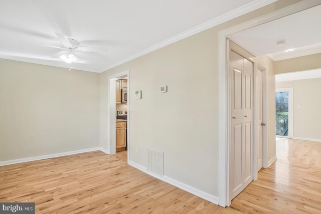 spare room with crown molding, ceiling fan, and light wood-type flooring