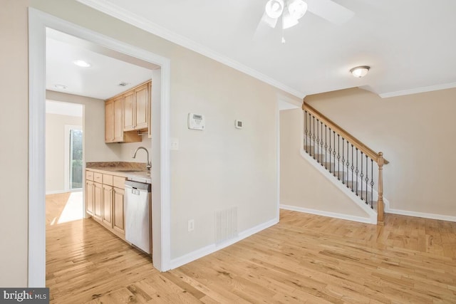 kitchen featuring sink, stainless steel dishwasher, light wood-type flooring, light brown cabinetry, and ornamental molding