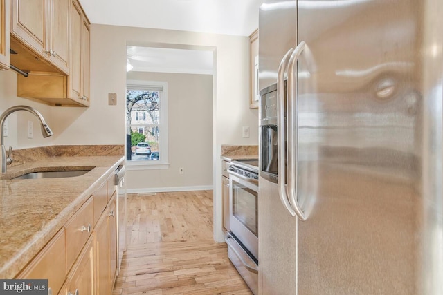 kitchen featuring sink, light hardwood / wood-style flooring, ornamental molding, light brown cabinetry, and appliances with stainless steel finishes