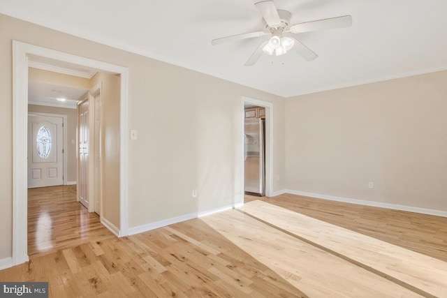 unfurnished room featuring ceiling fan, crown molding, and light hardwood / wood-style flooring