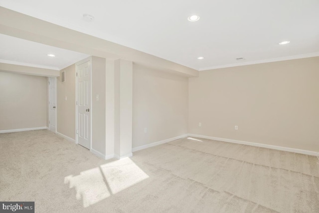 spare room with light colored carpet and ornamental molding