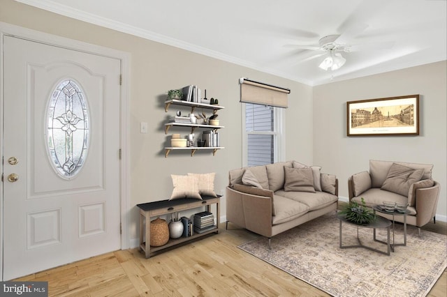 foyer featuring light hardwood / wood-style floors, ceiling fan, and ornamental molding