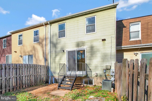 rear view of house with central AC unit