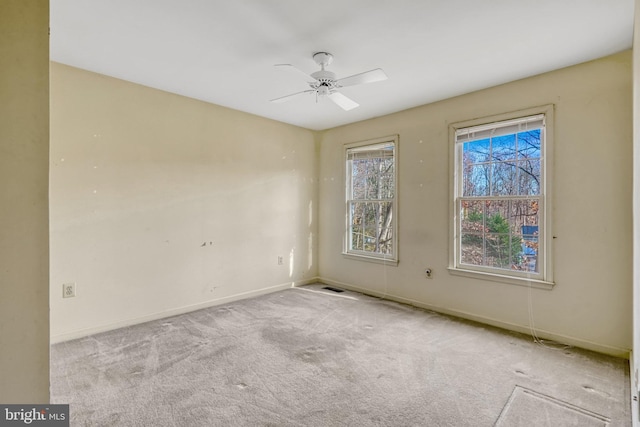 carpeted spare room with ceiling fan