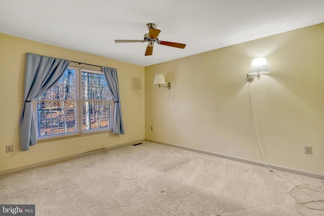 unfurnished room featuring ceiling fan and light colored carpet