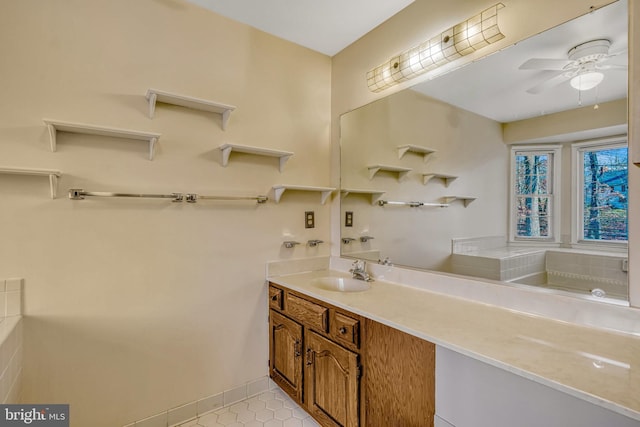 bathroom featuring tile patterned flooring, vanity, ceiling fan, and a bathing tub