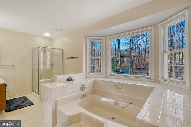 bathroom with tile patterned flooring, shower with separate bathtub, and vanity