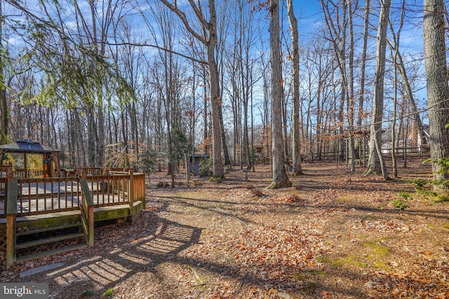 view of yard with a gazebo and a wooden deck