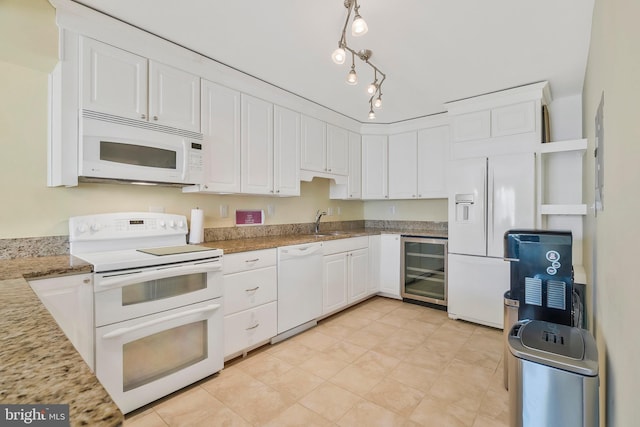 kitchen with white appliances, sink, wine cooler, light stone counters, and white cabinetry