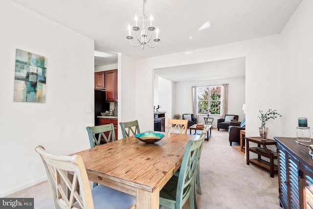 carpeted dining space with an inviting chandelier