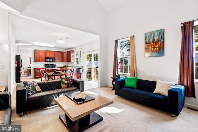 living room with light carpet and vaulted ceiling