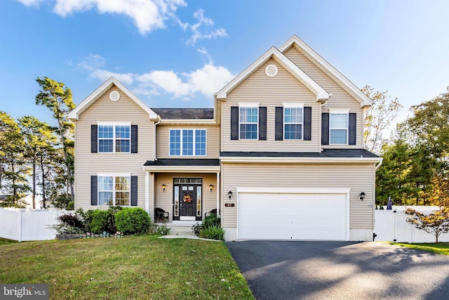 view of front of house featuring a front yard and a garage