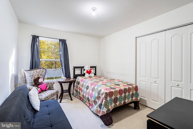 bedroom with light carpet and a closet