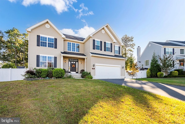 view of front of home featuring a front yard and a garage