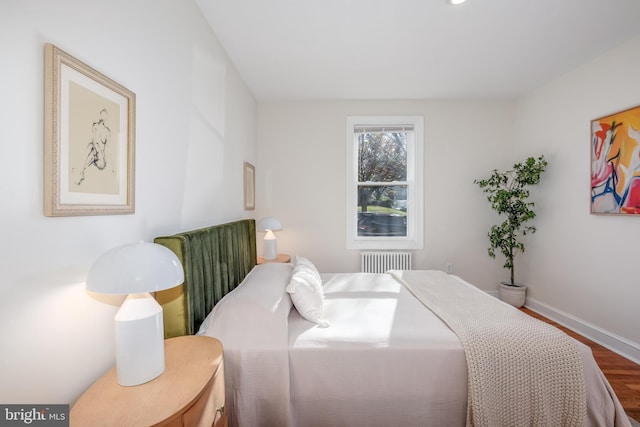 bedroom featuring wood-type flooring and radiator