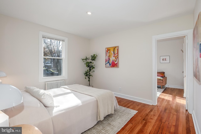 bedroom featuring hardwood / wood-style floors and radiator