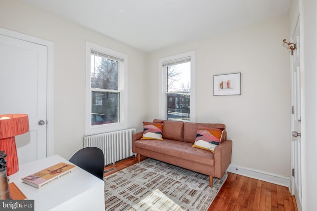 home office featuring radiator heating unit and light hardwood / wood-style floors