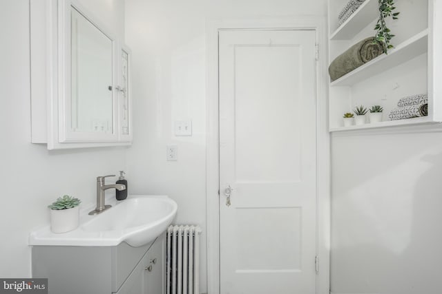 bathroom with radiator and vanity