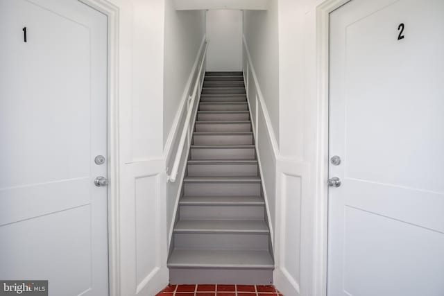 stairway with tile patterned floors