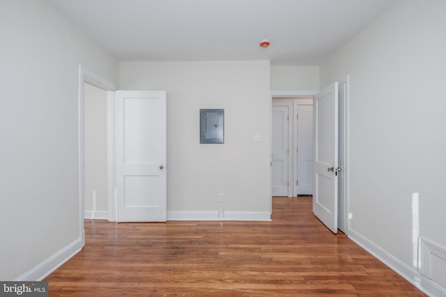 unfurnished bedroom featuring electric panel and wood-type flooring