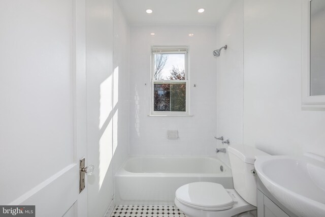 full bathroom with tiled shower / bath, tile patterned flooring, vanity, and toilet