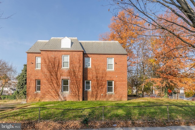 view of side of property with a lawn