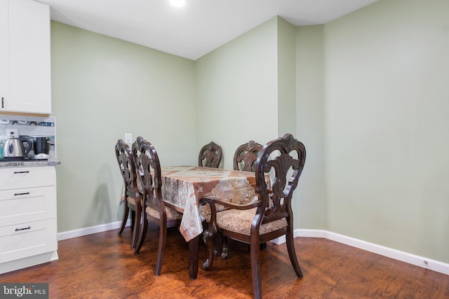 dining space with dark wood-type flooring