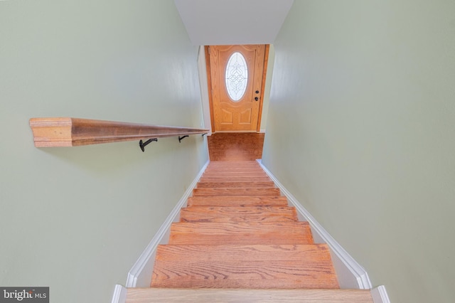 stairs featuring wood-type flooring