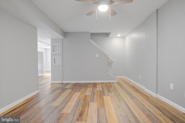 basement with ceiling fan and light wood-type flooring