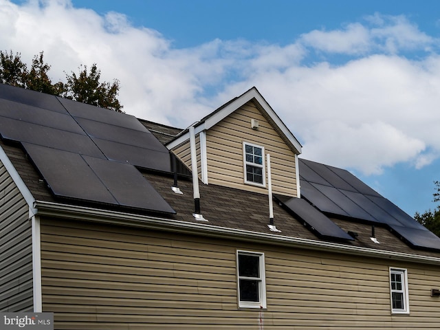 view of side of home with solar panels