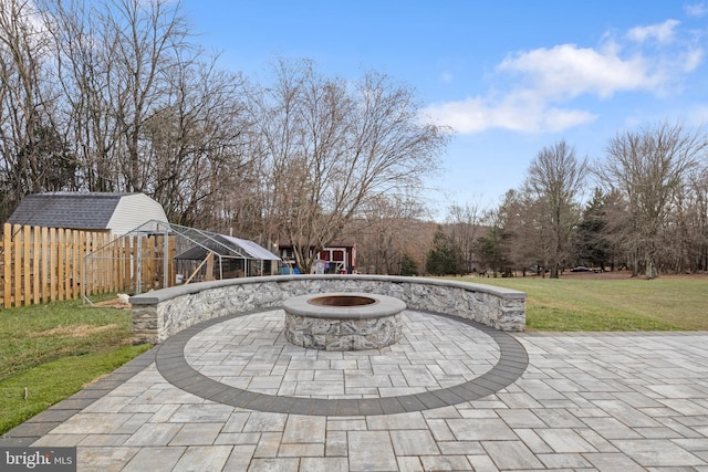 view of patio / terrace featuring a fire pit and a shed