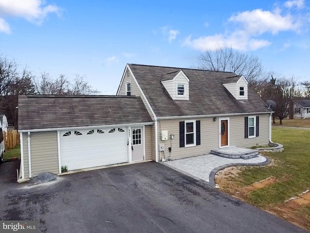 new england style home featuring a front yard and a garage