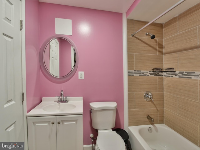 full bathroom with vanity, tiled shower / bath combo, and toilet