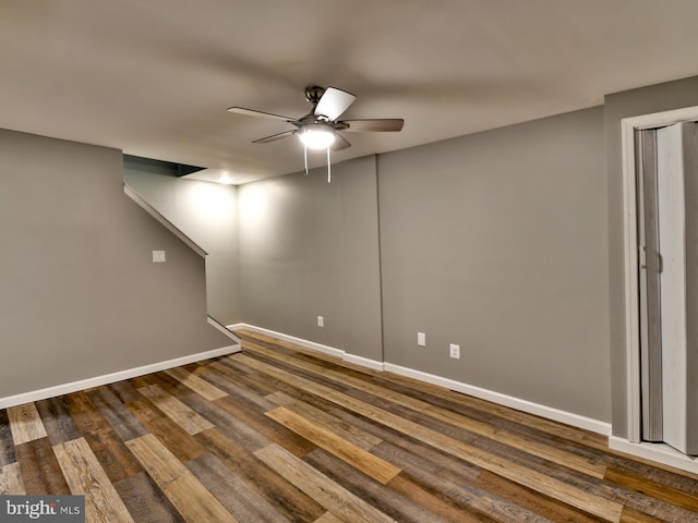 basement with ceiling fan and dark hardwood / wood-style floors