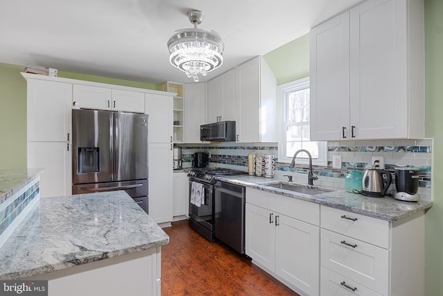 kitchen featuring black appliances, white cabinets, and sink