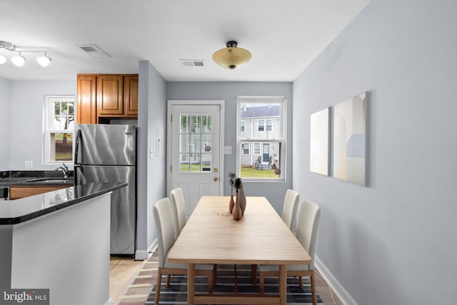 tiled dining area featuring sink